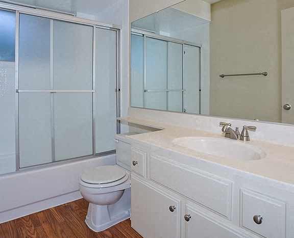 a bathroom with a sink toilet and a mirror